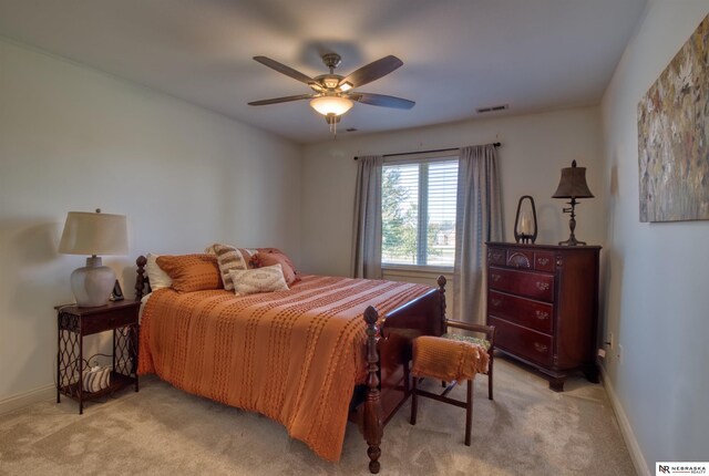 bedroom with ceiling fan and light colored carpet