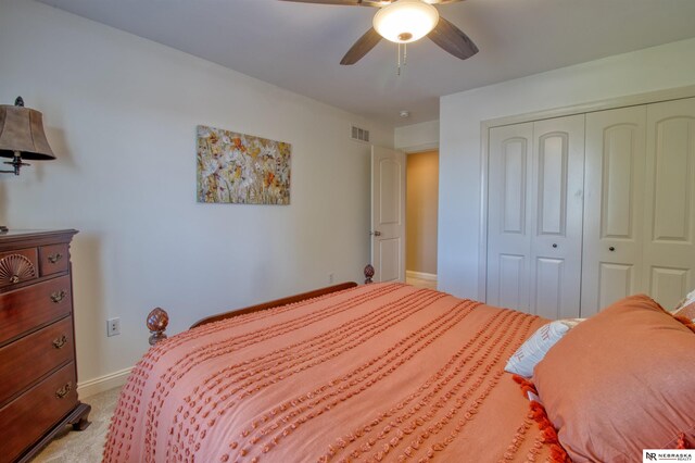 carpeted bedroom with a closet and ceiling fan