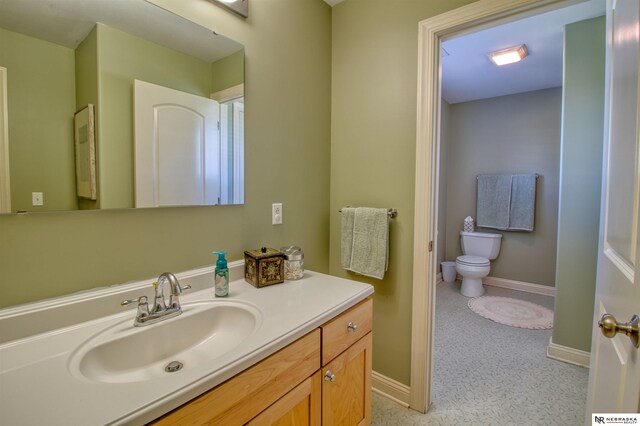 bathroom with vanity and toilet