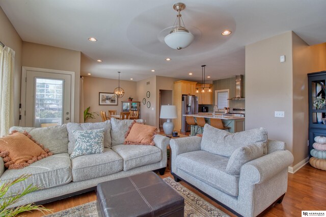 living room with hardwood / wood-style flooring and sink