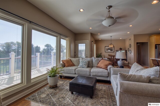 living room with ceiling fan, hardwood / wood-style flooring, and a healthy amount of sunlight