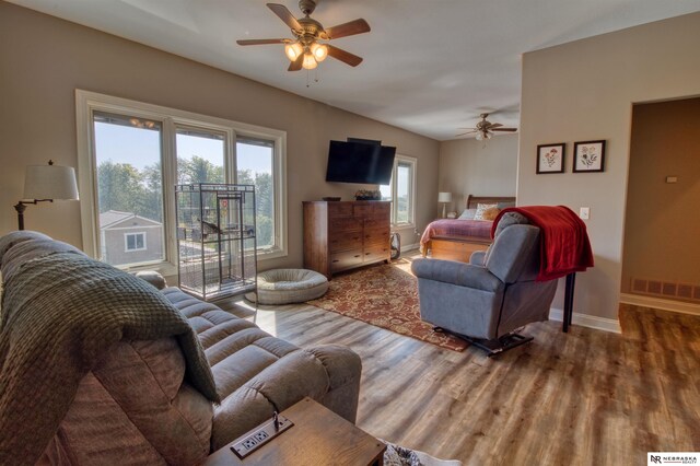 living room featuring hardwood / wood-style flooring, ceiling fan, and plenty of natural light