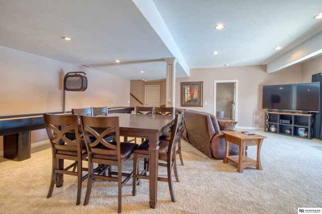 carpeted dining area with ornate columns