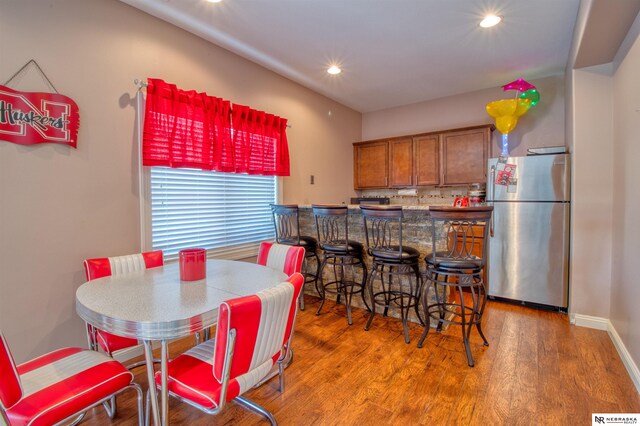 dining space with hardwood / wood-style floors