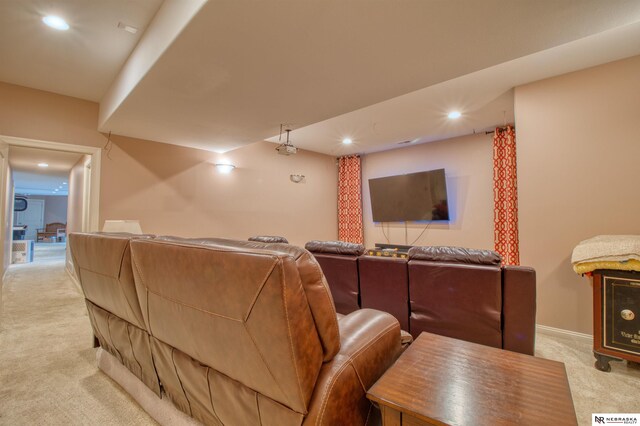 cinema room featuring light colored carpet