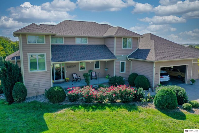 view of front of house featuring a garage and a front yard