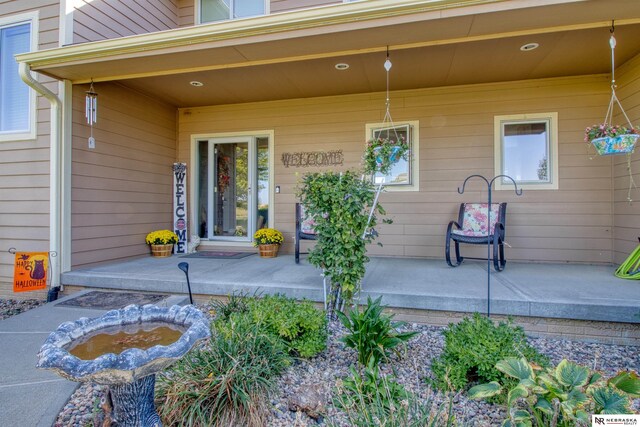 view of exterior entry featuring a porch