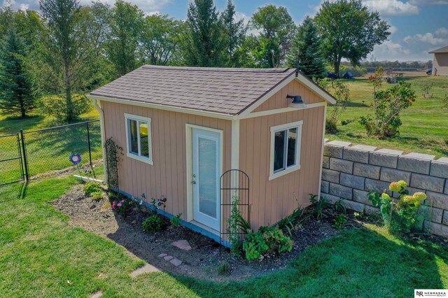 view of outbuilding featuring a yard