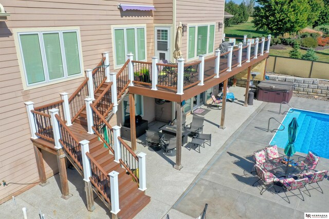 view of swimming pool with a wooden deck and a patio area