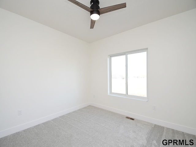 spare room with ceiling fan and carpet floors