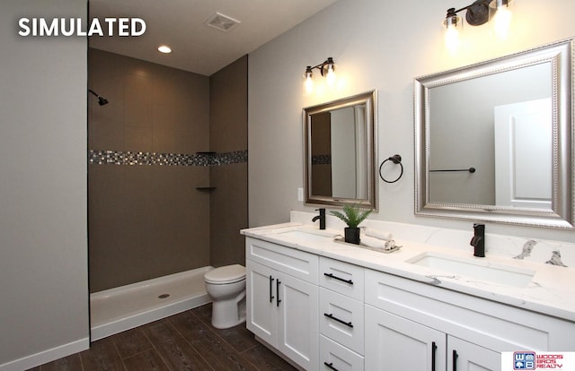 bathroom featuring hardwood / wood-style floors, vanity, toilet, and walk in shower