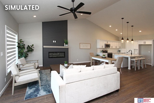 living room featuring sink, vaulted ceiling, ceiling fan, a large fireplace, and dark hardwood / wood-style flooring