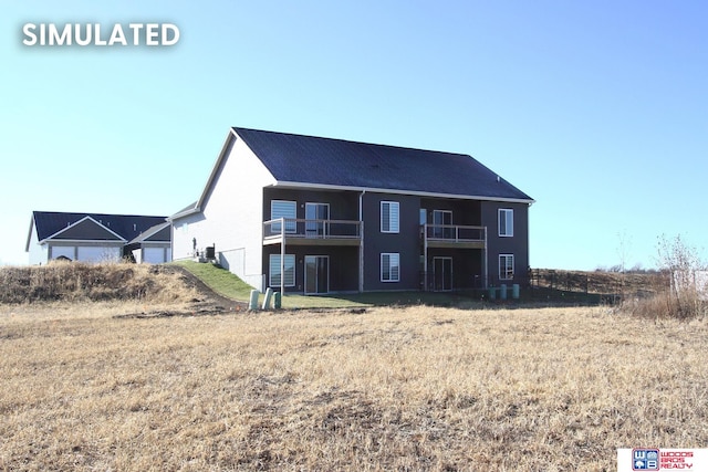 rear view of property featuring a balcony