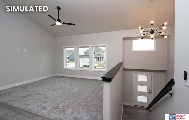 entryway featuring ceiling fan with notable chandelier, vaulted ceiling, and carpet floors