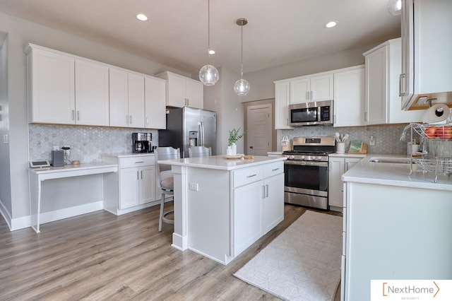 kitchen featuring stainless steel appliances and white cabinetry