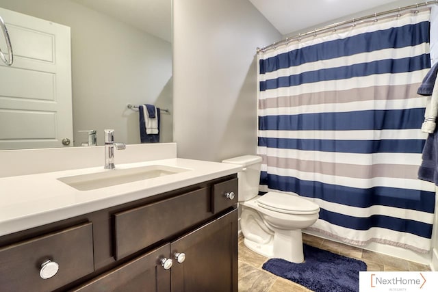 bathroom featuring tile patterned floors, a shower with curtain, vanity, and toilet