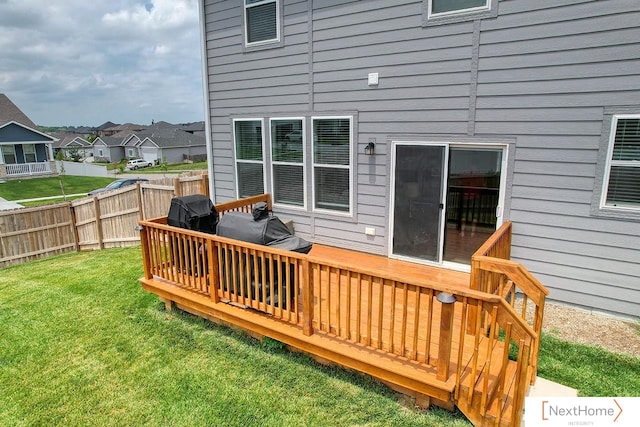 deck with a lawn and area for grilling