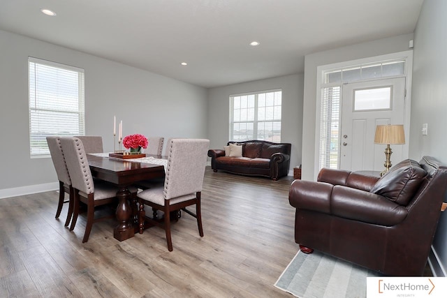 dining room with light hardwood / wood-style flooring and a wealth of natural light