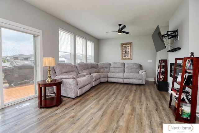 living room featuring wood-type flooring and ceiling fan