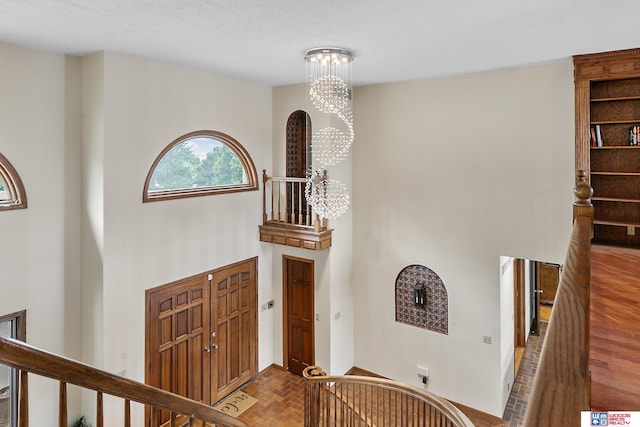 interior space with a notable chandelier and parquet flooring