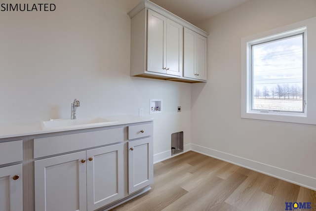 laundry room featuring sink, cabinets, hookup for a washing machine, light wood-type flooring, and electric dryer hookup