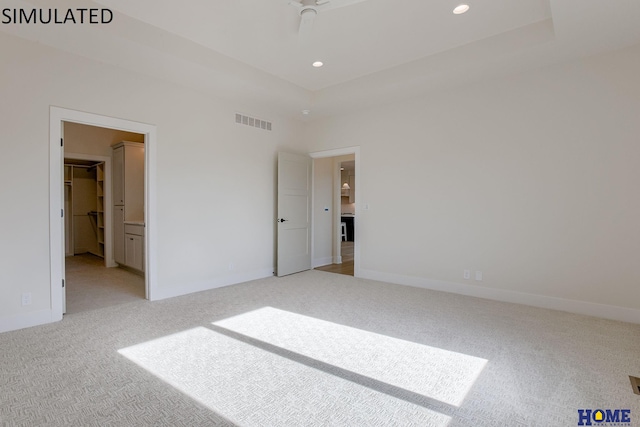 unfurnished bedroom with light carpet, ensuite bath, and ceiling fan