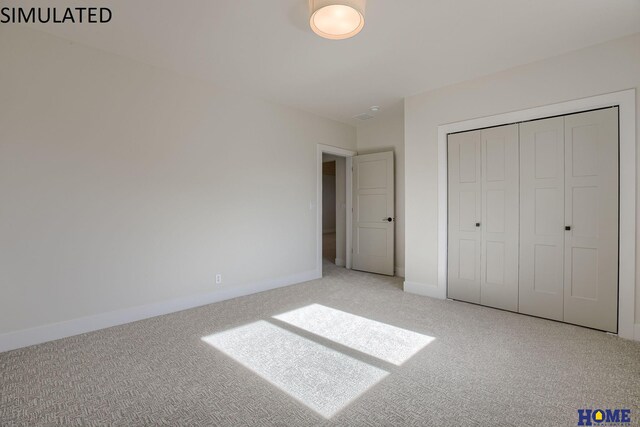 unfurnished bedroom featuring light colored carpet and a closet