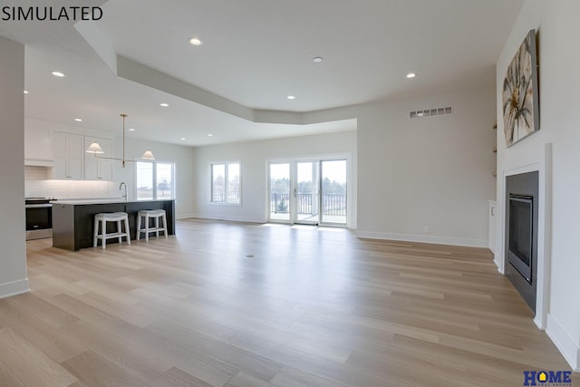 unfurnished living room with light hardwood / wood-style floors