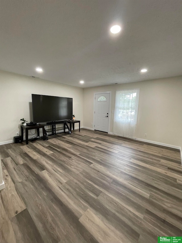 living room featuring a textured ceiling and dark hardwood / wood-style flooring