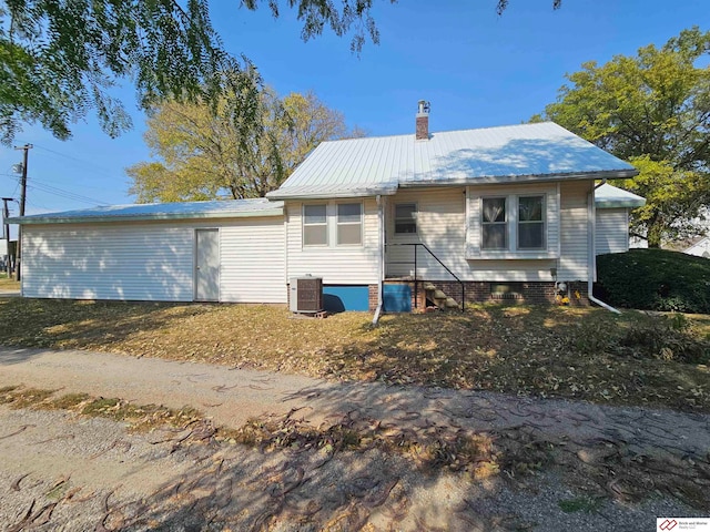 back of property featuring central AC unit