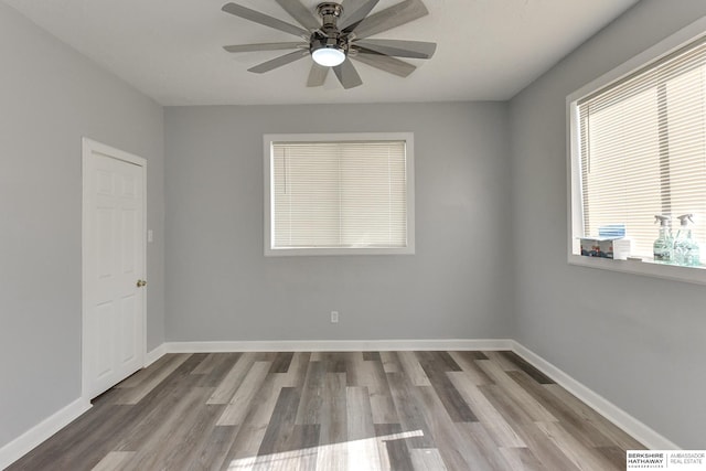 spare room with light wood-type flooring and ceiling fan