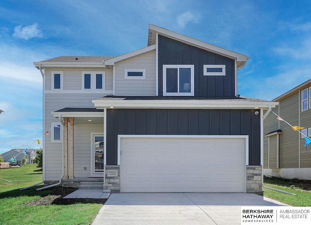 view of front of home with a front yard and a garage