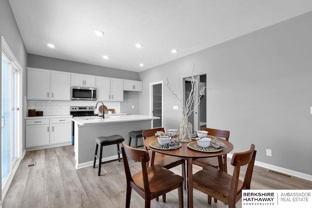 dining area with light hardwood / wood-style flooring