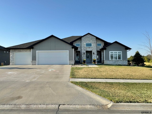 view of front of house featuring a garage and a front lawn