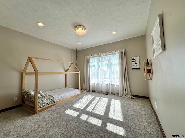 unfurnished bedroom featuring a textured ceiling and carpet flooring