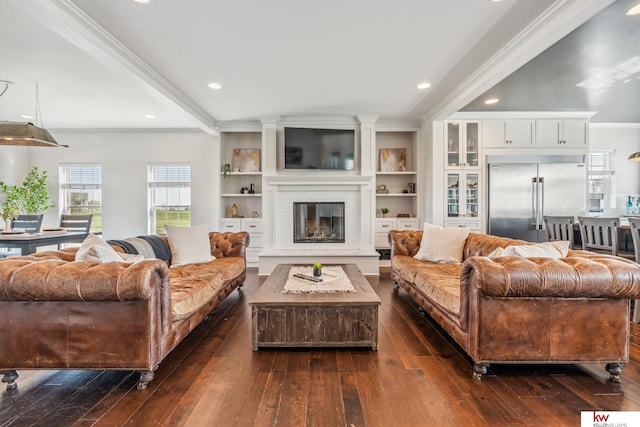 living room with ornamental molding, dark hardwood / wood-style floors, and built in shelves