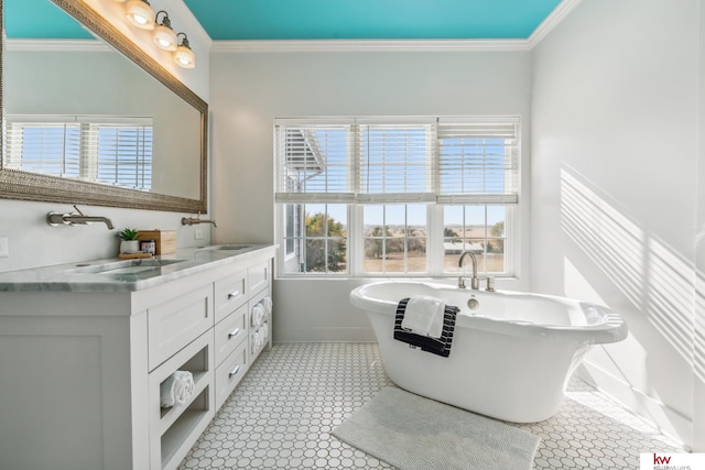 bathroom featuring vanity, a tub to relax in, a healthy amount of sunlight, and crown molding