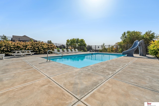 view of pool featuring a patio and a water slide