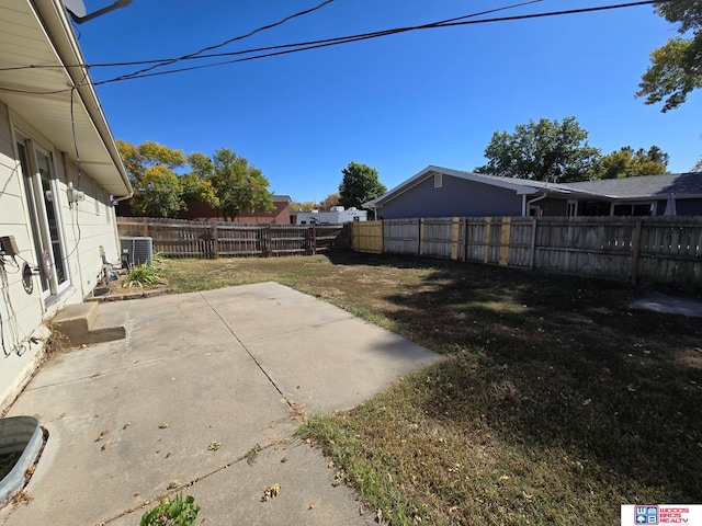 view of yard with cooling unit and a patio area