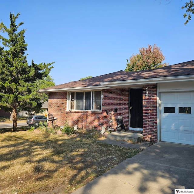 ranch-style home with a front yard and a garage