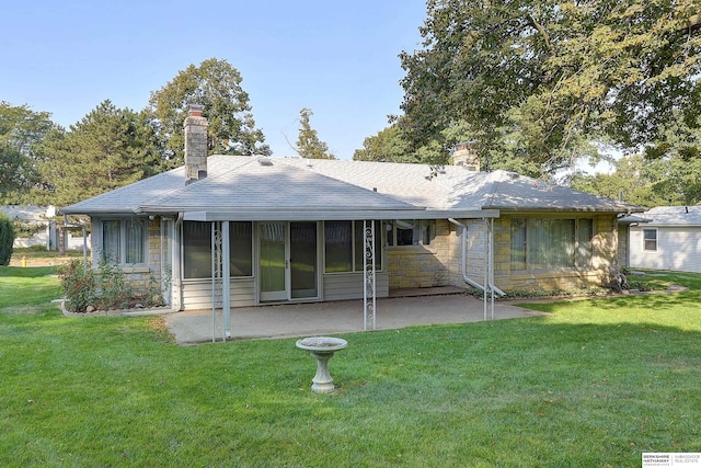 back of property featuring a yard and a patio area