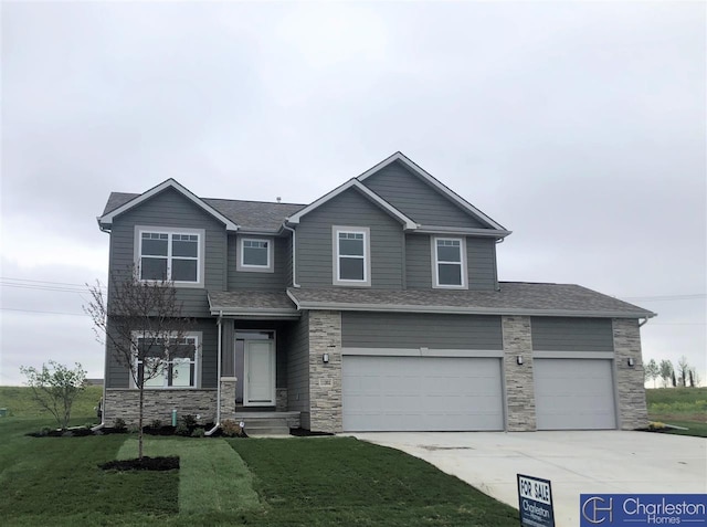 view of front of house featuring a front yard and a garage