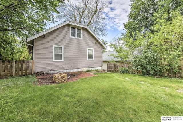 view of side of home featuring a yard