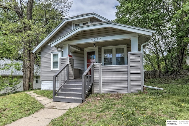 bungalow-style home featuring a porch and a front lawn