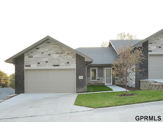 view of front of property with a garage and a front lawn