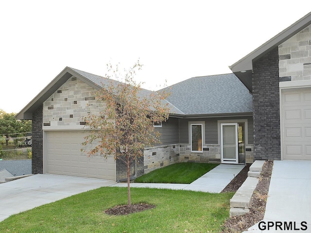 view of front of home with a garage and a front lawn