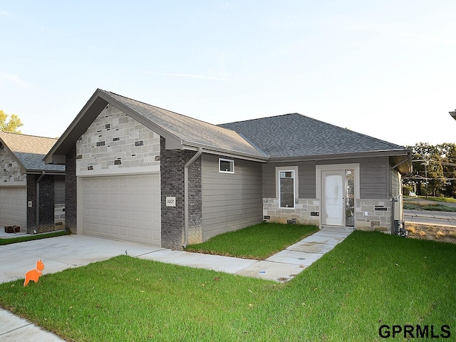 view of front of home with a front yard and a garage