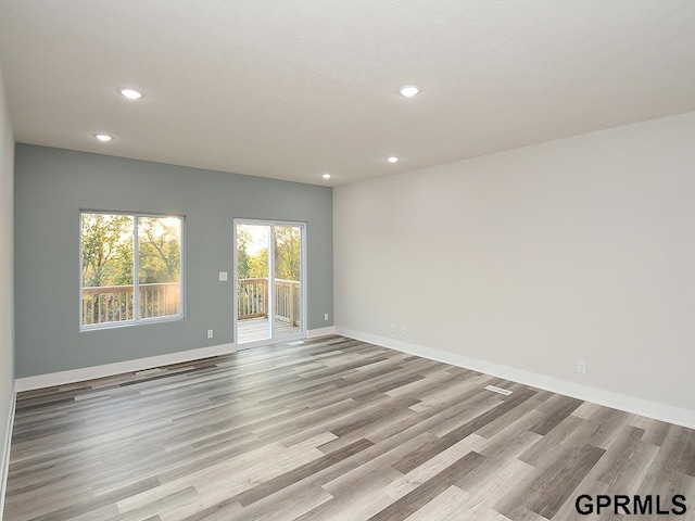 unfurnished room with light hardwood / wood-style floors