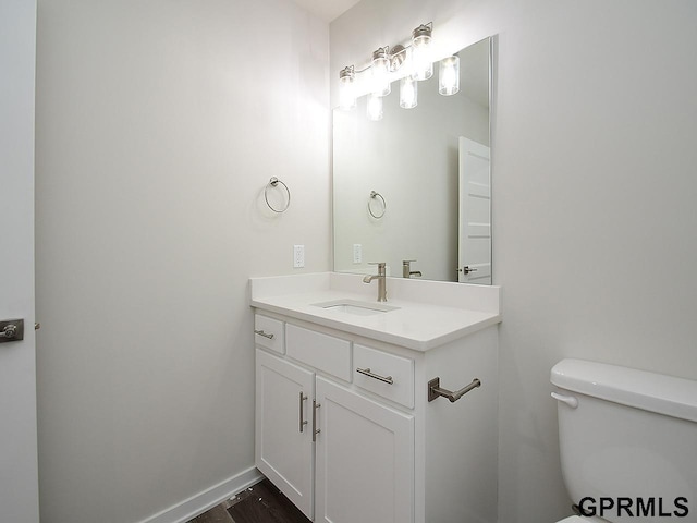 bathroom with vanity, hardwood / wood-style floors, and toilet