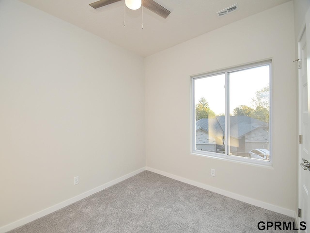 empty room with ceiling fan and light colored carpet